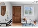 Cozy living room with a wooden door, sleek furniture, and bright natural light at 610 E Baseline Rd, Lafayette, CO 80026