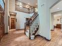 Grand foyer with hardwood floors, a staircase, and plenty of natural light at 19748 E Pinewood Dr, Aurora, CO 80016