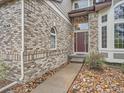 Close up on the front entrance of a brick house with manicured landscaping at 19748 E Pinewood Dr, Aurora, CO 80016