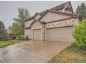 Spacious two-car garage with an extended driveway, perfect for parking multiple vehicles at 19748 E Pinewood Dr, Aurora, CO 80016