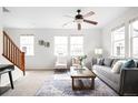 Bright living room with large windows, neutral décor, and a cozy seating area at 17200 Waterhouse Cir # D, Parker, CO 80134