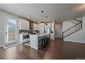 Modern kitchen featuring a large island with seating and stainless steel appliances at 6805 Canosa St, Denver, CO 80221