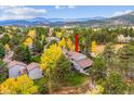A stunning aerial view of the property surrounded by lush trees and mountain landscape at 2356 Hiwan Dr # 40, Evergreen, CO 80439