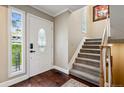 Welcoming foyer with hardwood floors, elegant front door, and staircase at 2356 Hiwan Dr # 40, Evergreen, CO 80439