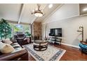 Cozy living room with a stone fireplace, vaulted ceilings, and comfortable leather furniture at 2356 Hiwan Dr # 40, Evergreen, CO 80439