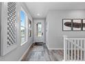Bright foyer with wood floors, stylish décor, and a staircase leading to the upper level at 2020 Sagerock Dr, Castle Pines, CO 80108