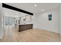Spacious dining area adjacent to the kitchen with an open floor plan and natural light at 671 Elati St, Denver, CO 80204