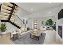 Staged living room featuring a contemporary design, fireplace, and views of the outdoors at 671 Elati St, Denver, CO 80204