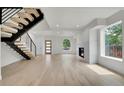 Bright living room with modern staircase, fireplace, and beautiful hardwood floors at 671 Elati St, Denver, CO 80204