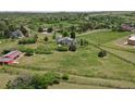 Scenic aerial view of a secluded home featuring a large fenced yard and lush greenery at 9163 N Palomino Dr, Castle Rock, CO 80108