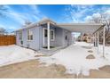 Ranch style home with carport and snowy yard at 15235 W 43Rd Ave, Golden, CO 80403