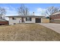 Inviting single-story home with a modern garage door and freshly painted white exterior at 2765 S Winona Ct, Denver, CO 80236
