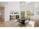 Bright living room features high ceilings, a fireplace, and large windows overlooking the backyard at 4340 Nelson Dr, Broomfield, CO 80023