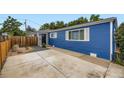 Attractive blue home featuring a private driveway and modern landscaping with charming wooden accents at 1021 Stuart St, Denver, CO 80204