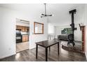 Open concept living space features a wood burning stove, and adjacent dining and kitchen at 9832 High St, Thornton, CO 80229