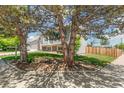 Landscaped front yard featuring mature trees that provide shade and privacy for the home at 5886 S Nepal Way, Centennial, CO 80015