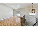 Bright living room featuring hardwood floors, large window, and a staircase leading upstairs at 5886 S Nepal Way, Centennial, CO 80015
