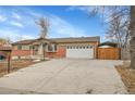 Charming ranch-style home with a large driveway and a two-car garage at 12022 W Dakota Dr, Lakewood, CO 80228