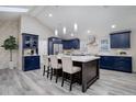 Stunning kitchen with blue cabinets, a large island, and modern pendant lighting at 6389 S Ponds Way, Littleton, CO 80123