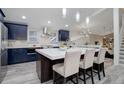 Spacious kitchen featuring a large island with seating and modern stainless steel appliances at 6389 S Ponds Way, Littleton, CO 80123