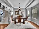 Elegant dining room featuring a large table, chandelier, and hardwood floors at 12198 Tack Dr, Parker, CO 80134