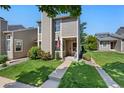 Inviting townhome featuring a well-maintained lawn and charming front porch at 4691 S Fraser Cir # A, Aurora, CO 80015