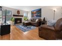 Cozy living room featuring a fireplace and a comfortable leather sectional at 4691 S Fraser Cir # A, Aurora, CO 80015