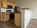 Modern kitchen featuring stainless steel appliances and a breakfast bar area at 15475 E Andrews Dr # 402, Denver, CO 80239