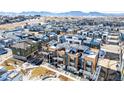 Community aerial showcasing modern townhouses, landscaping, and mountain views in the background at 2361 Junegrass Ln, Louisville, CO 80027