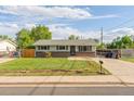 Inviting single-story home featuring lush front yard and a convenient driveway at 2630 W Asbury Ave, Denver, CO 80219