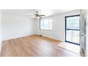 Bright, airy living room with hardwood floors, large window, and secure front door at 2630 W Asbury Ave, Denver, CO 80219