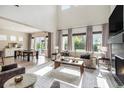 Inviting living room boasts large windows, stylish furnishings, and a cozy fireplace at 1195 Fox Hills Ct, Erie, CO 80516