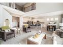 Open-concept living space with views of the kitchen, dining area, and a staircase leading to the upper level at 1195 Fox Hills Ct, Erie, CO 80516