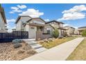 Attractive modern home with neutral siding, concrete walkway, and curated landscaping enhancing the curb appeal at 2339 W 66Th Ave, Denver, CO 80221