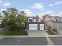 Two-story home with a three-car garage, landscaped yard, and inviting curb appeal at 12695 Wolff St, Broomfield, CO 80020