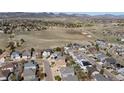 Expansive aerial view showing the neighborhood's layout near open space and mountains in the background at 7019 S Garrison St, Littleton, CO 80128