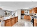 Charming kitchen featuring stainless steel appliances, tile countertop, and wood cabinets at 2281 Coronado Pkwy # D, Denver, CO 80229