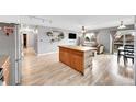 Open floorplan featuring kitchen, dining area, and living room with hardwood floors at 2281 Coronado Pkwy # D, Denver, CO 80229