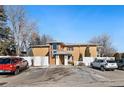 Exterior shot of a well-maintained apartment building and parking area in winter at 705 S Clinton # 2A, Denver, CO 80247