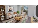 Bright living room featuring a sofa, accent chair, coffee table, rug, and a large window for natural light at 5779 Taft Trl, Arvada, CO 80002