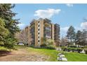Multi-story condo building featuring balconies and manicured green spaces on a sunny day at 14300 E Marina Dr # 512, Aurora, CO 80014