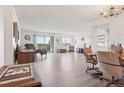 Bright, spacious living room featuring wood-look floors, dining area, and balcony access at 14300 E Marina Dr # 512, Aurora, CO 80014