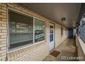 Exterior hallway with 'For Sale' sign in the window at 1723 Robb St # 44, Lakewood, CO 80215