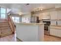 Modern kitchen with stainless steel appliances and breakfast bar at 5690 W 80Th Pl # 91, Arvada, CO 80003