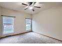 Bright bedroom featuring neutral carpet, a ceiling fan and two windows with views at 7971 Larkspur Cir # 219, Frederick, CO 80530