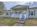 Charming exterior with a covered front porch, white railings, and meticulous landscaping at 7971 Larkspur Cir # 219, Frederick, CO 80530