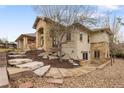The backyard is landscaped with stone steps, gravel beds, and a covered patio with a grill at 6071 S Detroit St, Centennial, CO 80121