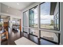 Bright and airy living room with expansive windows offering scenic views of the surrounding landscape at 8765 Canyon Wind St, Parker, CO 80138