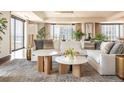 Cozy living room featuring a plush sectional sofa, modern decor, and bright lighting with a large area rug at 1133 14Th St # 2000, Denver, CO 80202