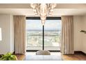 Bright room with large windows showcasing a panoramic city view and a modern lighting fixture at 1133 14Th St # 2000, Denver, CO 80202